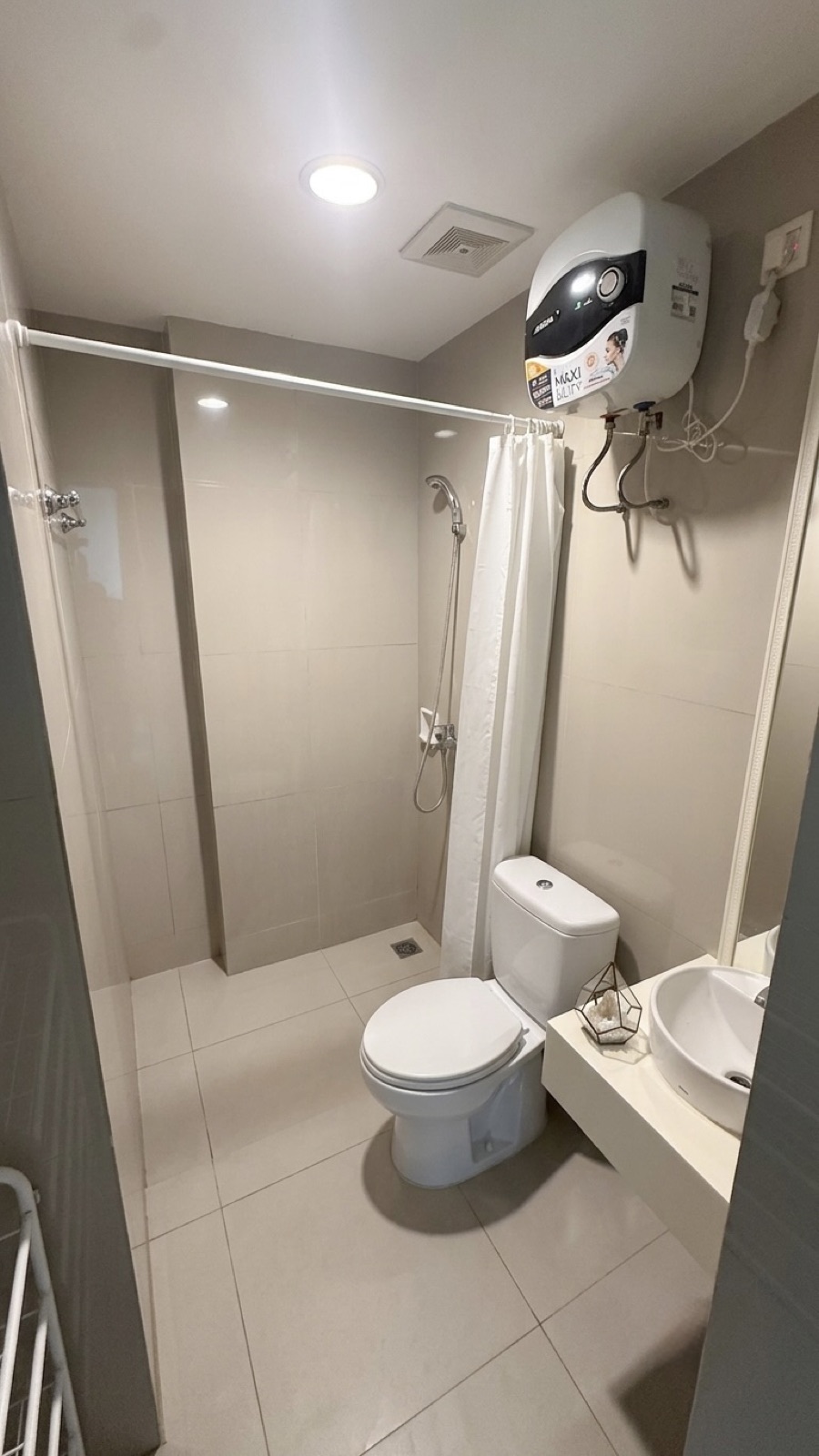 Bathroom with walk-in shower, water heater and basin