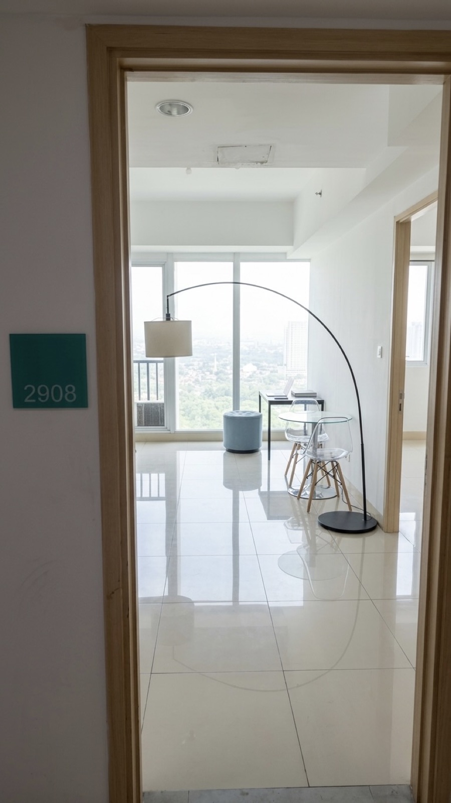 Open door of unit 2908 looking into the sunlit living area