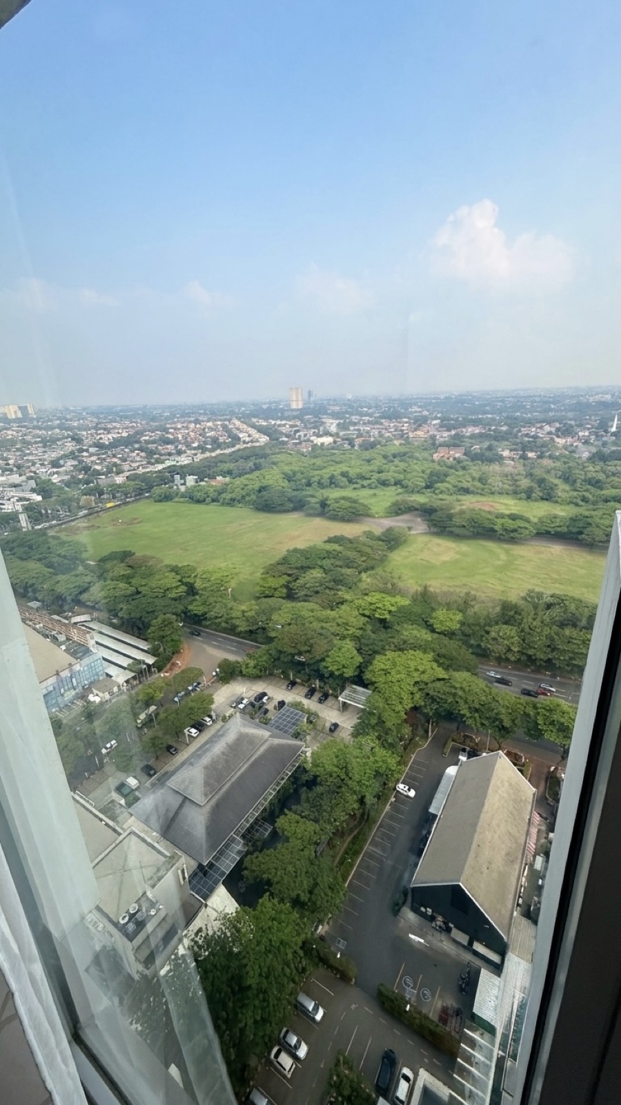 Aerial view from the unit over a vast green park and BSD City